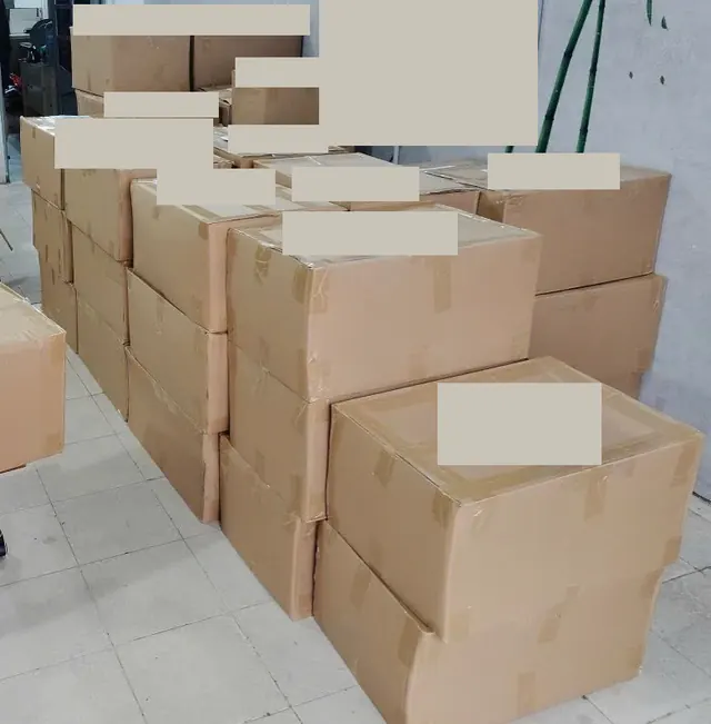 Sealed cardboard cartons with shipping labels concealed
