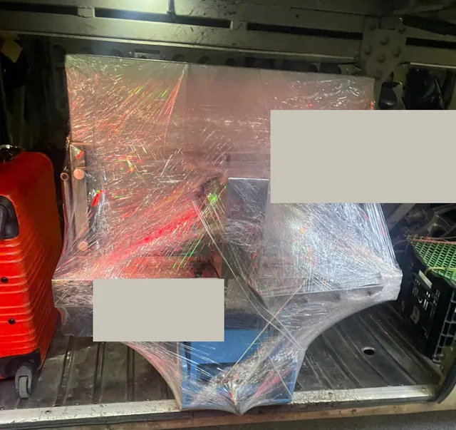 Equipment protected with stretch film; handwriting and people concealed